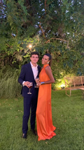 Elegant couple outdoors, man in navy suit, woman in orange evening dress, ZAPDRESS style