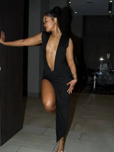 Woman in deep V black evening dress posing indoors, ZAPDRESS fashion