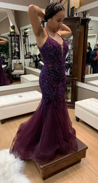 Woman trying on a sparkly purple mermaid prom dress at ZAPDRESS boutique