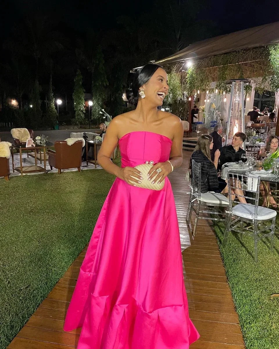 Woman in a bright pink strapless evening gown at outdoor event, ZAPDRESS fashion