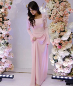 Woman in elegant pink dress standing between floral arrangements, ZAPDRESS fashion showcase
