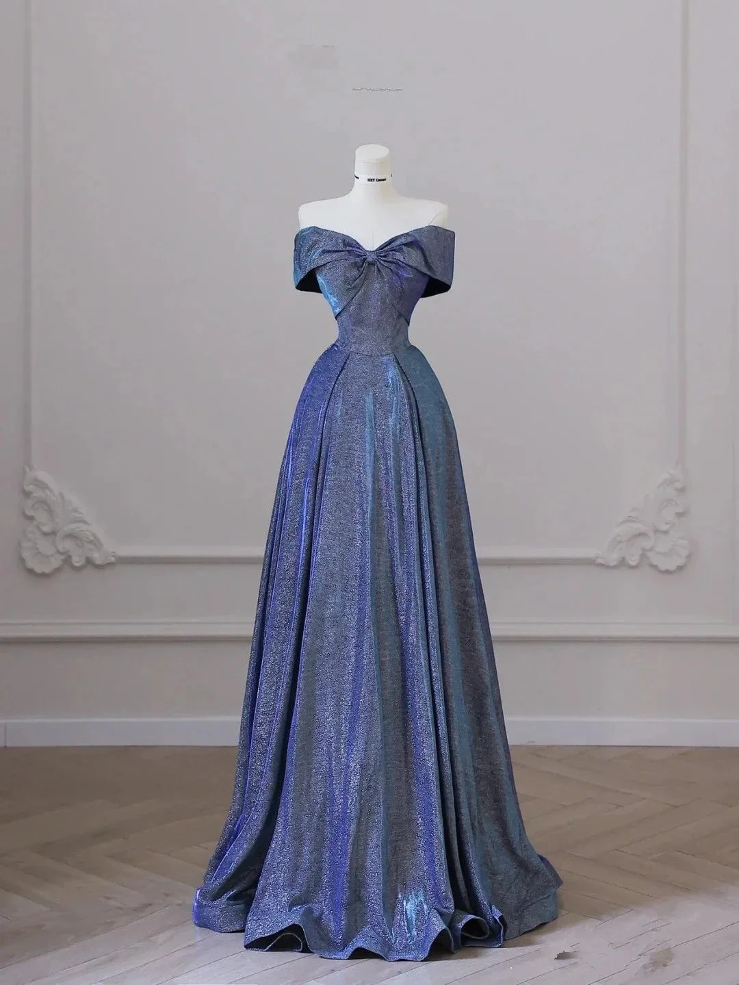 Iridescent off-shoulder evening gown on mannequin in elegant room, ZAPDRESS fashion