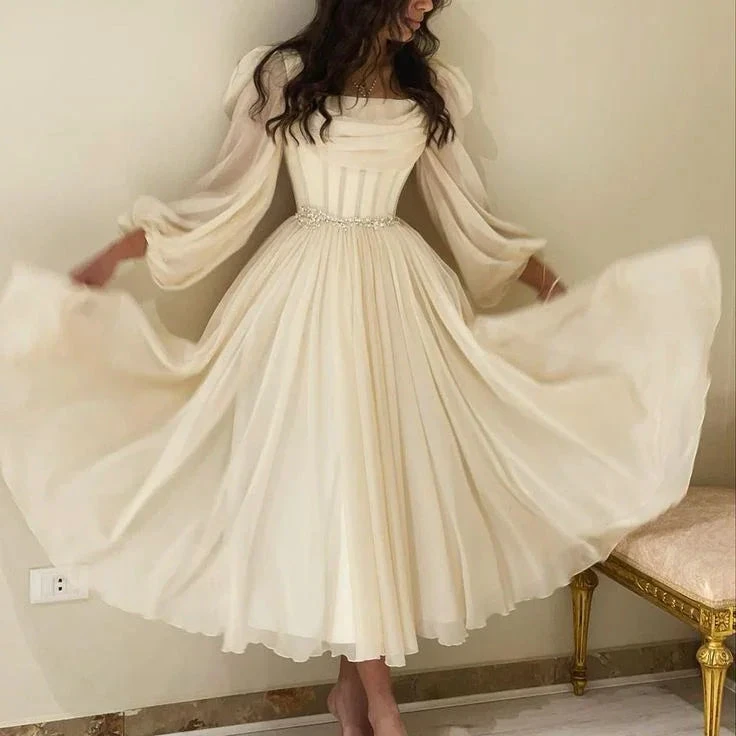 Woman wearing elegant long cream dress with sheer sleeves, ZAPDRESS fashion style