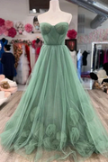 Elegant green tulle strapless gown with floral details, displayed in ZAPDRESS boutique