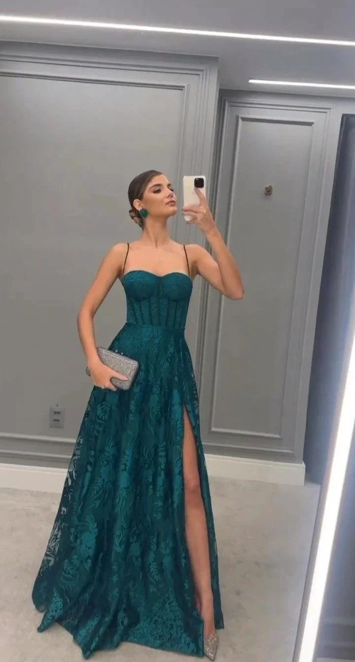 Woman in elegant teal evening dress with lace details taking mirror selfie at ZAPDRESS