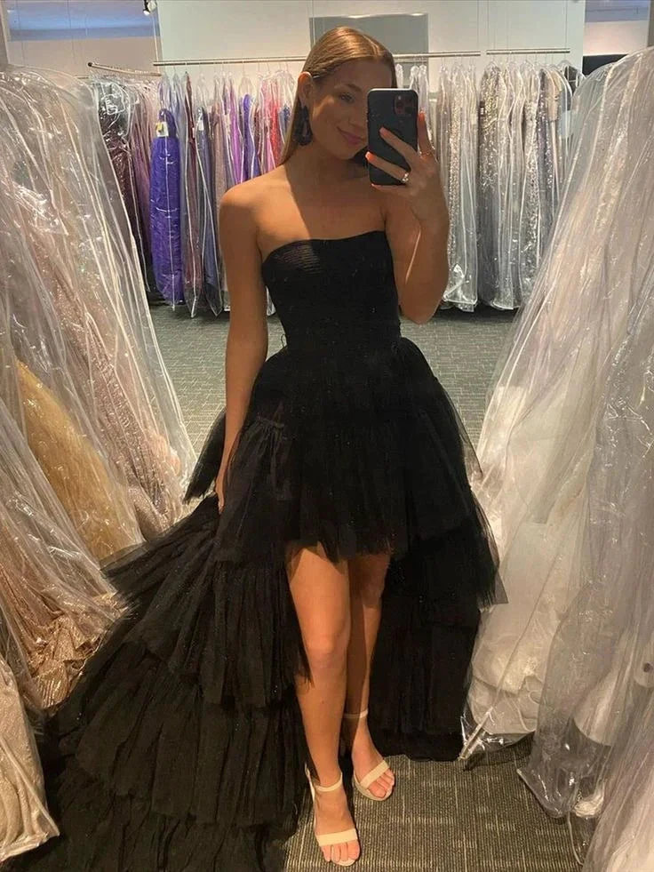 Woman in black strapless high-low tulle dress posing in boutique, ZAPDRESS fashion mirror selfie