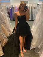 Woman in black strapless high-low tulle dress posing in boutique, ZAPDRESS fashion mirror selfie