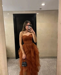 Woman in a strapless ruffled brown evening dress taking a mirror selfie, holding a small handbag, ZAPDRESS fashion