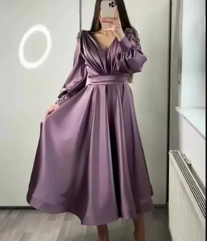 Woman wearing a satin purple long sleeve midi dress from ZAPDRESS mirror selfie
