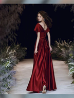 Woman in elegant deep red satin evening gown on a runway, ZAPDRESS fashion style