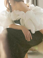 Woman in off-shoulder black dress with large white ruffled sleeves, ZAPDRESS fashion