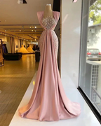 Elegant blush pink evening gown with sequin bodice on mannequin in ZAPDRESS boutique window