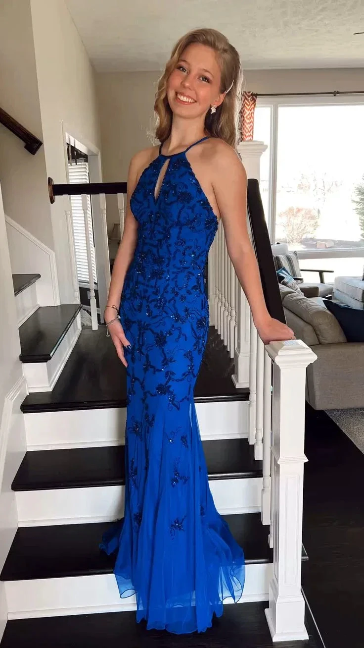 Smiling woman in royal blue beaded evening dress on staircase, ZAPDRESS fashion