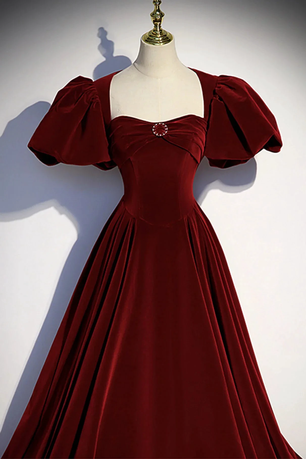 Elegant burgundy velvet dress with puff sleeves and jeweled brooch from ZAPDRESS