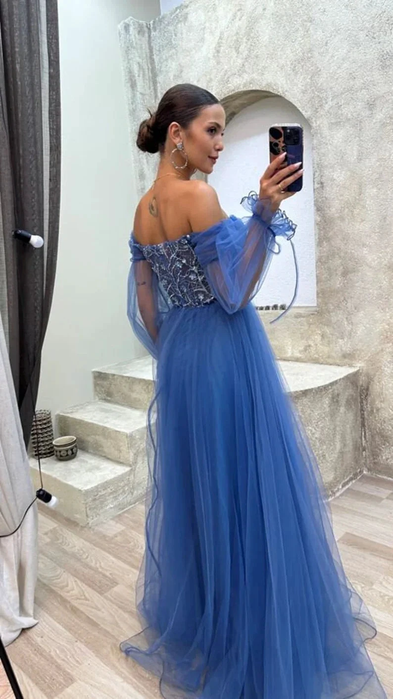 Woman taking mirror selfie in off-shoulder blue tulle evening dress at ZAPDRESS boutique