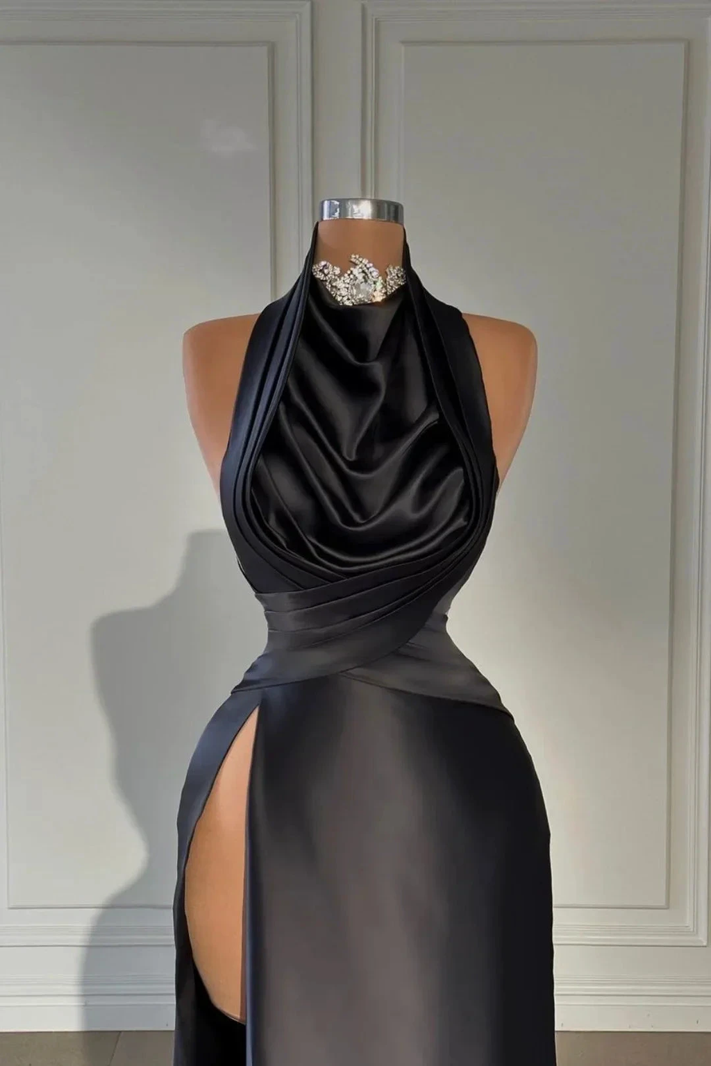 Elegant black satin evening dress with high slit on mannequin, Zapdress fashion