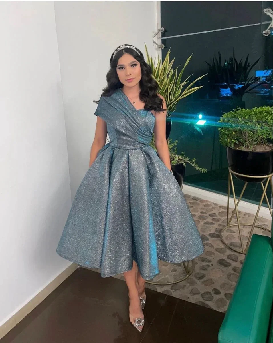 Woman in sparkly silver one-shoulder dress at indoor event, ZAPDRESS fashion style