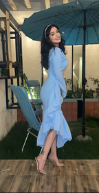 Woman in light blue ruffle dress and clear heels standing outdoors under blue umbrella, ZAPDRESS