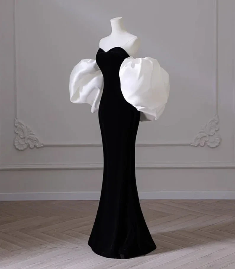 Elegant black evening gown with dramatic white puff sleeves on mannequin, ZAPDRESS fashion