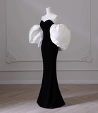 Elegant black evening gown with dramatic white puff sleeves on mannequin, ZAPDRESS fashion