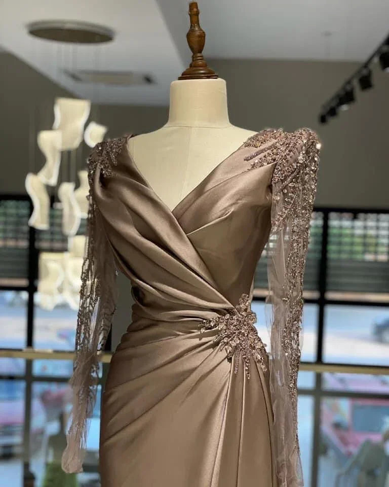 Elegant satin evening dress with beaded long sleeves on mannequin at ZAPDRESS boutique