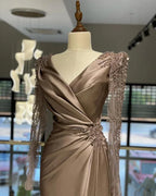 Elegant satin evening dress with beaded long sleeves on mannequin at ZAPDRESS boutique