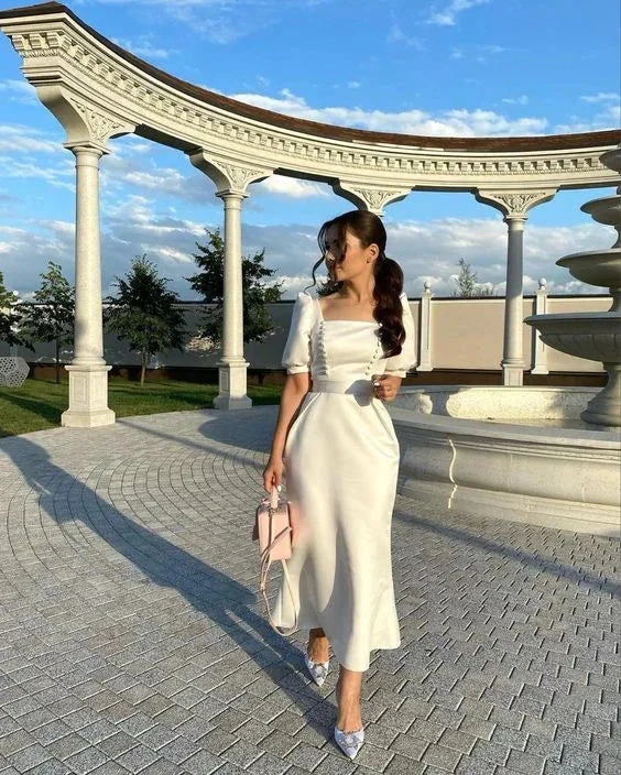 Woman in elegant white satin dress holding pink purse at outdoor marble pavilion, ZAPDRESS fashion