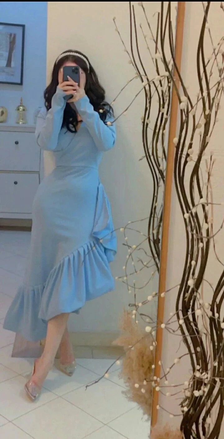 Woman in light blue ruffled dress taking a mirror selfie, stylish interior, ZAPDRESS fashion