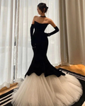 Elegant black and white mermaid gown with tulle skirt, model posing indoors for ZAPDRESS
