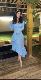 Woman in elegant light blue ruffle dress smiling outdoors, ZAPDRESS fashion style