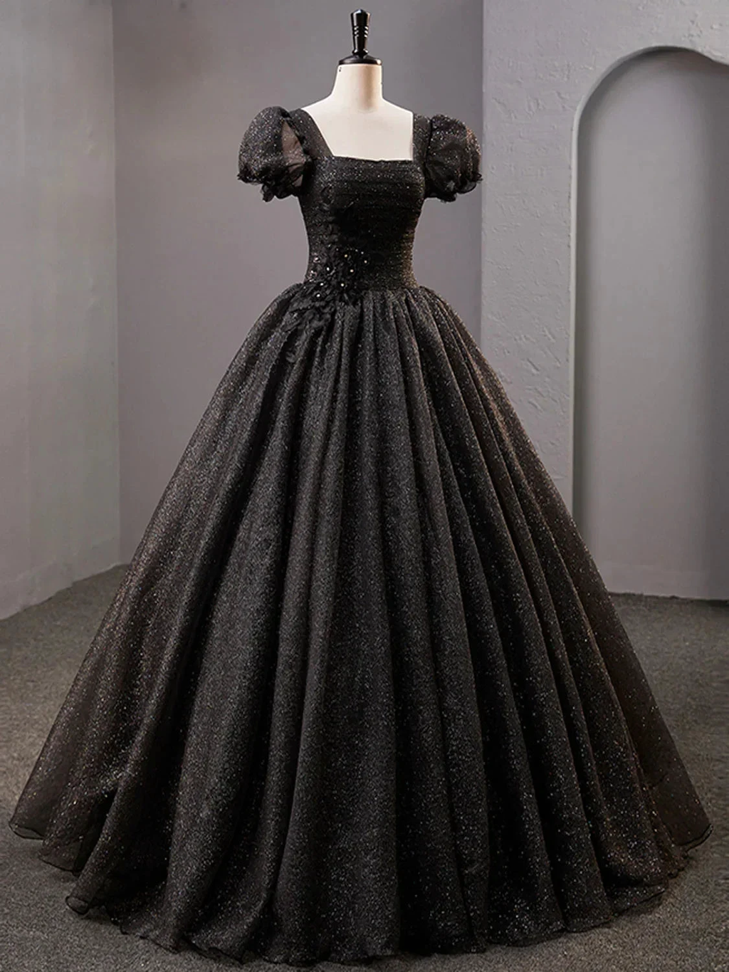 Elegant black ball gown dress with puff sleeves and glitter details on mannequin at ZAPDRESS