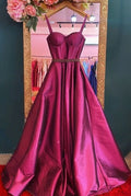 Elegant magenta satin evening gown with fitted bodice and full skirt on display at ZAPDRESS
