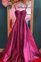 Elegant magenta evening gown with fitted bodice, displayed in ZAPDRESS boutique mirror.