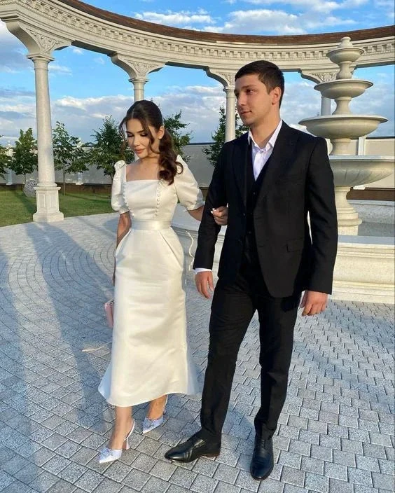 Elegant couple in formal attire at outdoor venue with white columns and fountain, ZAPDRESS style