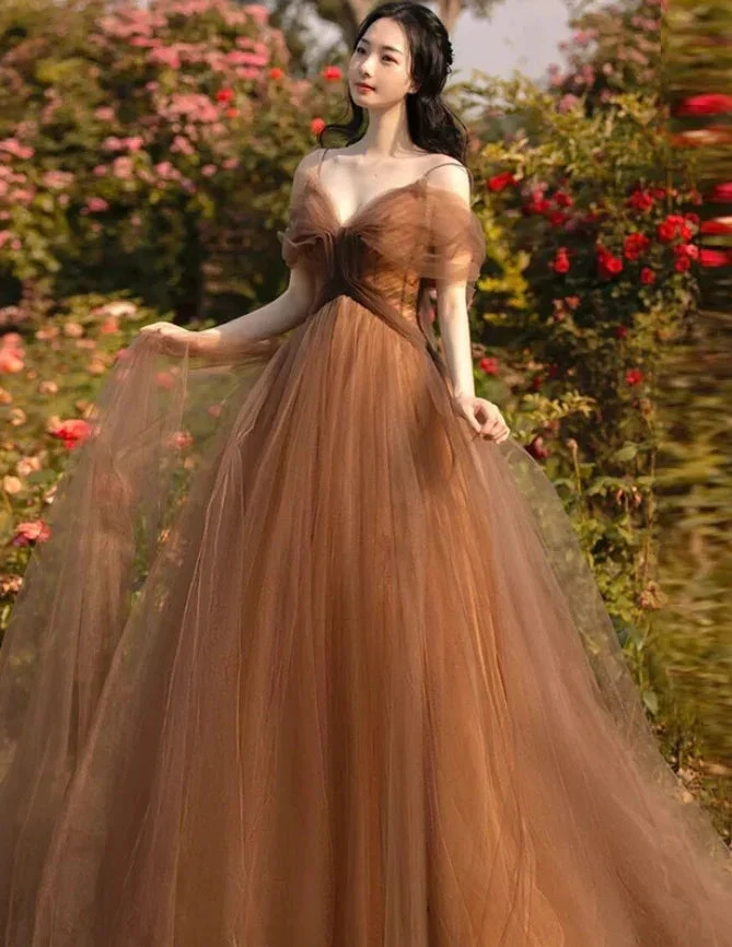 Woman in elegant brown tulle gown standing in a rose garden, ZAPDRESS fashion