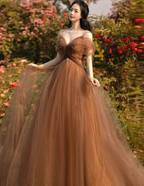 Woman in elegant brown tulle gown standing in a rose garden, ZAPDRESS fashion