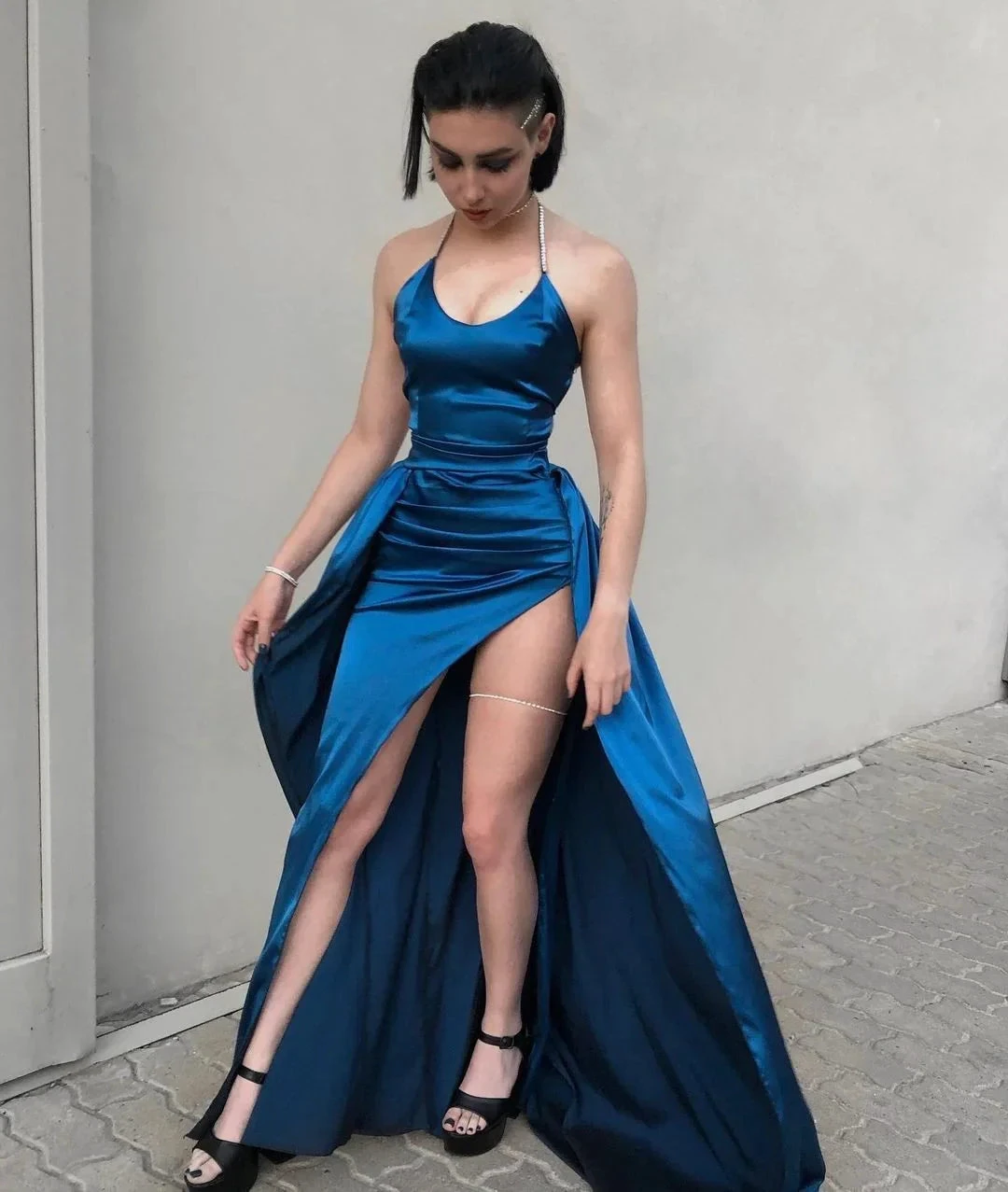 Woman in blue satin evening dress with high slit, outdoor, ZAPDRESS fashion.