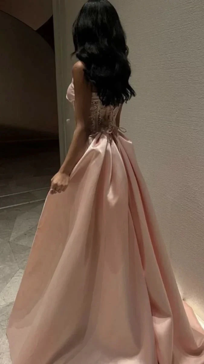 Woman in elegant pink satin evening gown with lace-up back, ZAPDRESS fashion style