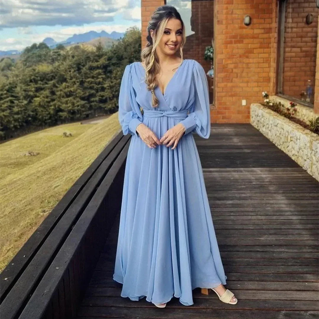 Woman in a flowing light blue maxi dress on a wooden deck, ZAPDRESS fashion