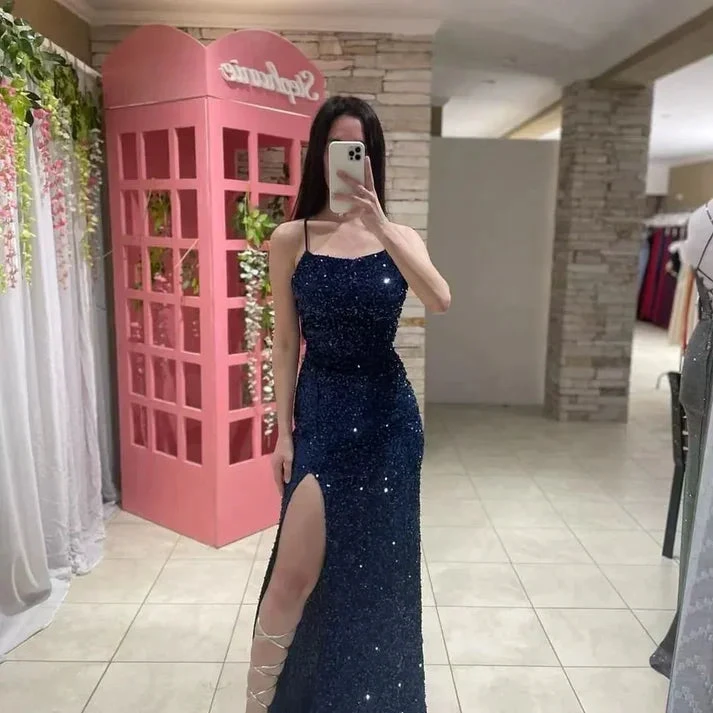 Woman in blue sequin evening dress with high slit at ZAPDRESS boutique, pink backdrop