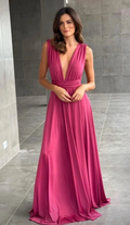 Woman in a deep V-neck pink maxi dress standing on gray tile, ZAPDRESS fashion